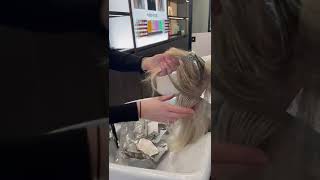 Removing hair foils at Jo Hansford's hair salon