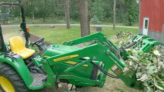 Moving brush piles-part 2-John Deere 3038E Tractor with grapple  #ourbighouseinthelittlewoods