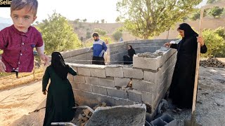 The determination of a nomadic family to build a shelter in the mountains