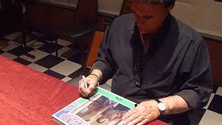 T.G. Sheppard signing autographs on record albums