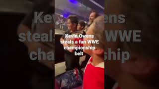 Kevin Owens steals a fan's WWE championship during a match