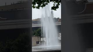 The fountain at centenary square Bradford mirror pool, being  blown in the wind