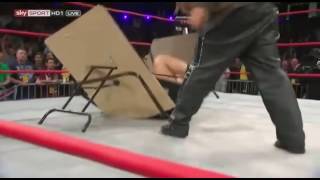 Abyss hits a Chokeslam on Bully Ray through a Table