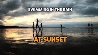 Swimming in the rain at sunset