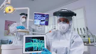 Doctor Showing Digital X-ray on Tablet in Dental Office with New Normal | Stock Footage - Envato...