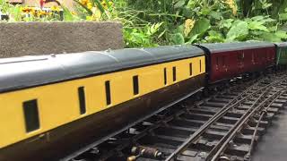 O gauge trains in the garden.