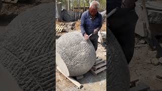 Stonemason carving a stone jar