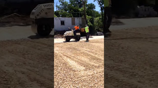 Compacting road base and prepping area for asphalt