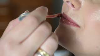 4K Free Stock Footage: Woman applying lip gloss