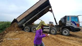 Great work Technique operator bulldozer pushing Stone Making New Road with dump truck dumping Stone.