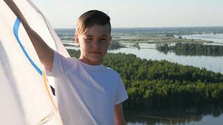 Boy waving flag the Olympic Games outdoors