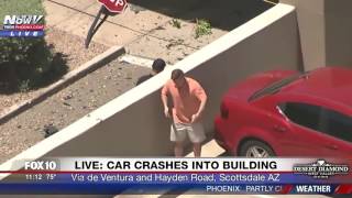 car crashes into building