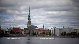 View through the Daugava River of Saint Peter's Church against the background of the cloudy sky