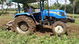 New Holland 4710 working on risky job