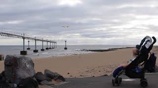 Baby watching low plane landing across sea beach, Matagorda Lanzarote. Canary Islands plane video