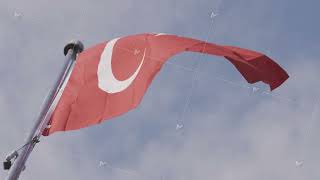 Turkish flag waving on bright blue sky background. Action. Bottom view of a red turkish swaying in