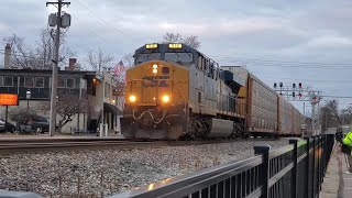 CSX 918, emerging from the hold out, slowly moves, stops, and departs while a northbound CSX passes.