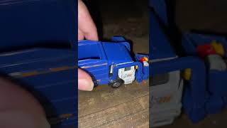 Toy garbage truck picking up dumpsters