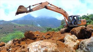 Hitachi Excavator Digging Rock And Dirt On The Hill