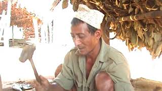 Blacksmith using traditional equipment made by goat skin |