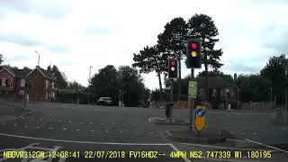 Crossing the path of oncoming traffic at a traffic light controlled crossroads.