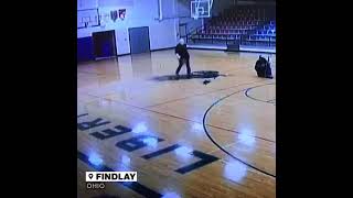 A custodian at a school in Ohio casually makes an amazing over the shoulder basket from half court.