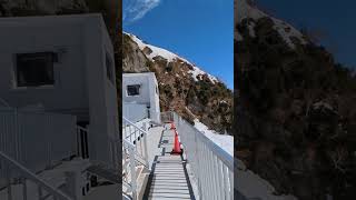 Japanese Alps, lake and snow melting as tiny waterfall, Alpine Kurobe route