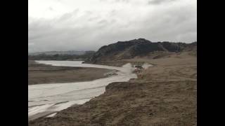 Yahoo splashing through creek at Oceano Dunes