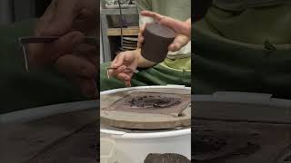 Trimming and adding handles to black stoneware espresso cups