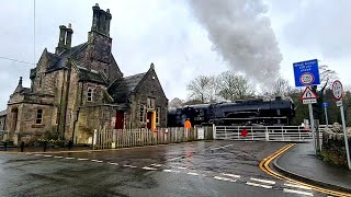 American steam loco bursts across level crossing in quiet corner of England