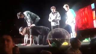 Louis making sure it's okay to climb on Harry's back