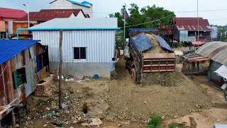 Push the earth to eliminate garbage behind the home. by truck and bulldozers is processing work