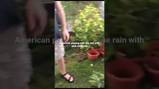 Watch my American husband playing with the rain with Pink Umbrella in the Philippines#shorts 😄😍