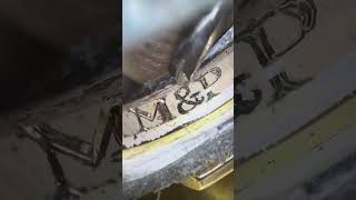 Jeweler is hand engraving the inside of rings!