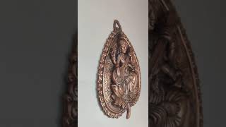 Saraswathi Devi on leaf antique looking metal wall hanging.