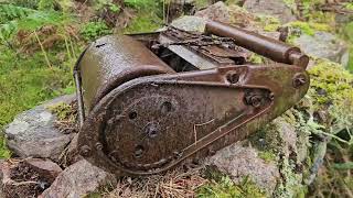 vintage lawnmower on stone wall