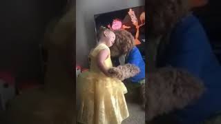 Little girl dancing with dog to beauty and the beast