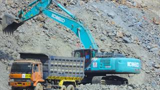 Excavator Dump Trucks Busy Working on THe River Valley Dam Construction Bendungan Bener