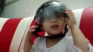 Kevin trying to wear his brother's helmet