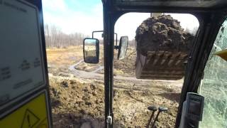 Cat 323F Excavator bailing dirt