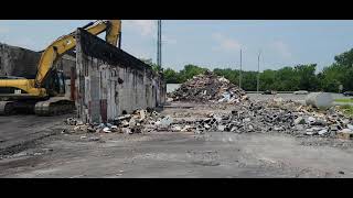 demo of Solomons strip mall knocking down block wall