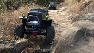 A pair of Axial Scx10ii trucks on trail