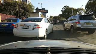 2011 Camry Hybrid driver holding phone and smoking. number plate CDT94R, Hume Highway, Liverpool