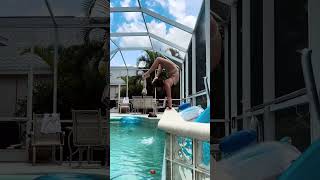 Woman is doing handstand tricks on the side of the pool!