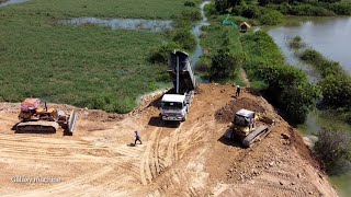 Mighty Powerful Extreme bulldozer komat'su D-58-P working Push soil with heavy dump truck  unloading