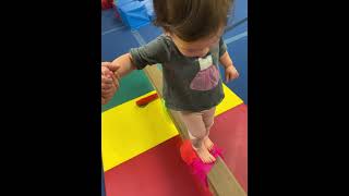 Sammi on balance beam at baby gymnastic class little gym