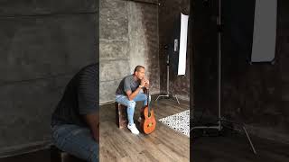 Nilton G - guitar on lap looking at camera (photoshoot)