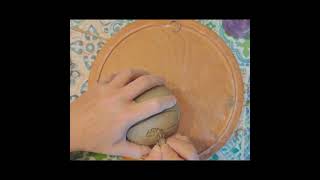 Carving a porcelain egg with stylized fern designs