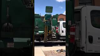 Waste management picking up a full trash can