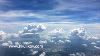 The top view on white clouds and the earth from the plane